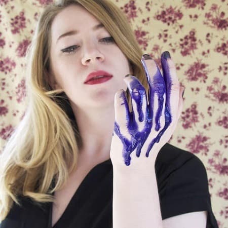 Woman Holding Purple Shampoo On Hand